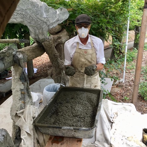 Terry Eagan mixes cement to repair faux bois trees