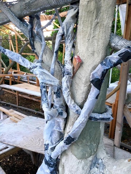 Wisteria vines protected from mortar mix.
