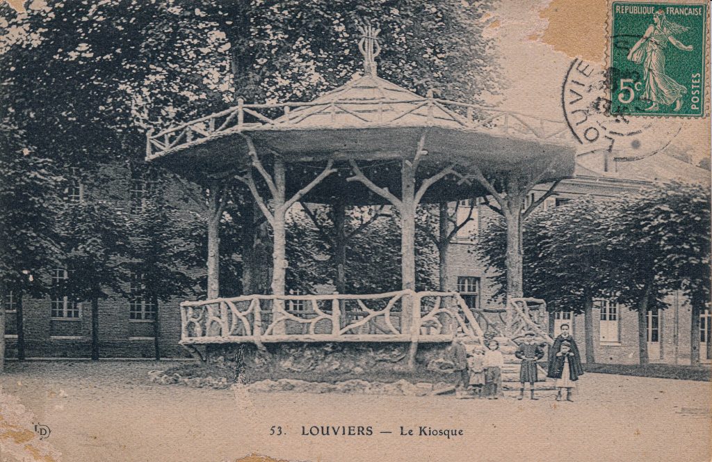 music kiosk with faux bois railings, with a roof held up with faux bois tree trunks