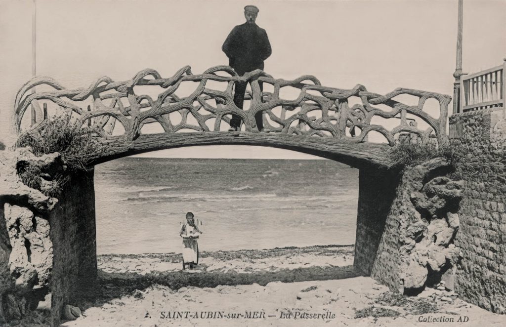 faux bois passerelle, a man standing on an oceanside faux bois bridge