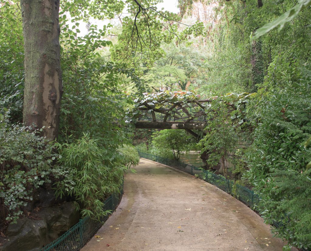 a faux bois bridge in Jardin de la Nouvelle France near the Grand Palais