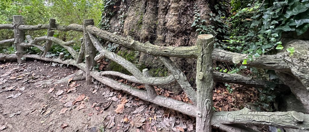 Old faux bois fence near base of Eiffel Tower with 200-year-old sycamore tree