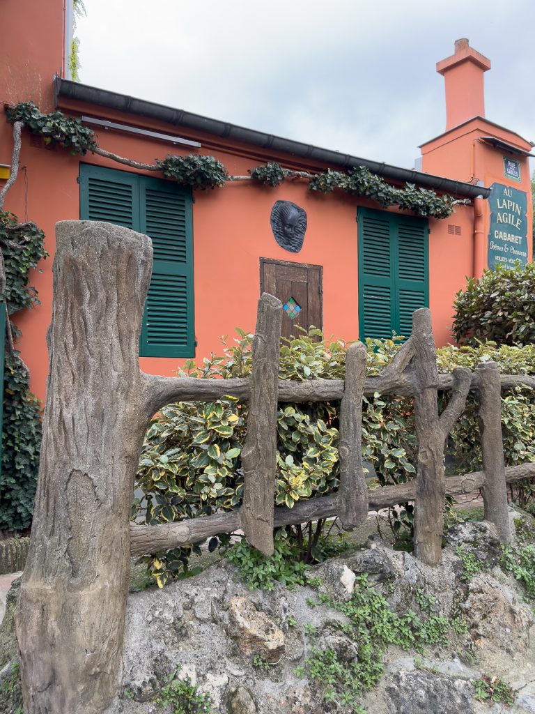 a rustic faux bois courtyard fence at Au Lapin Agile