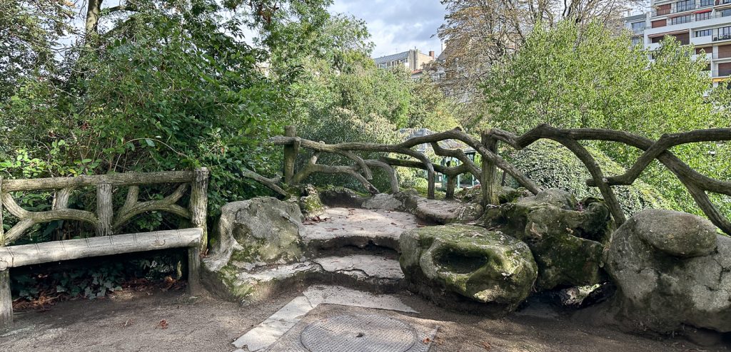 A faux bois railing above the cascade at Parc Montsouris