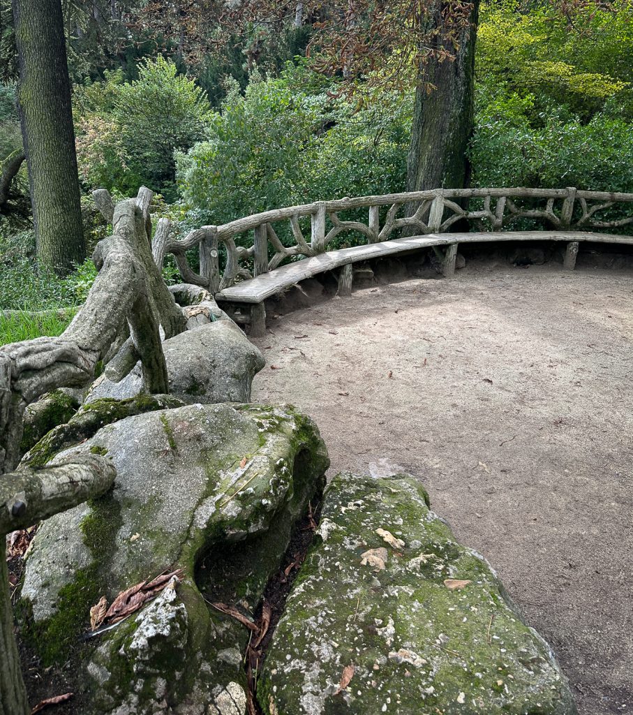 A faux bois railing and benches above the cascade at Parc Montsouris