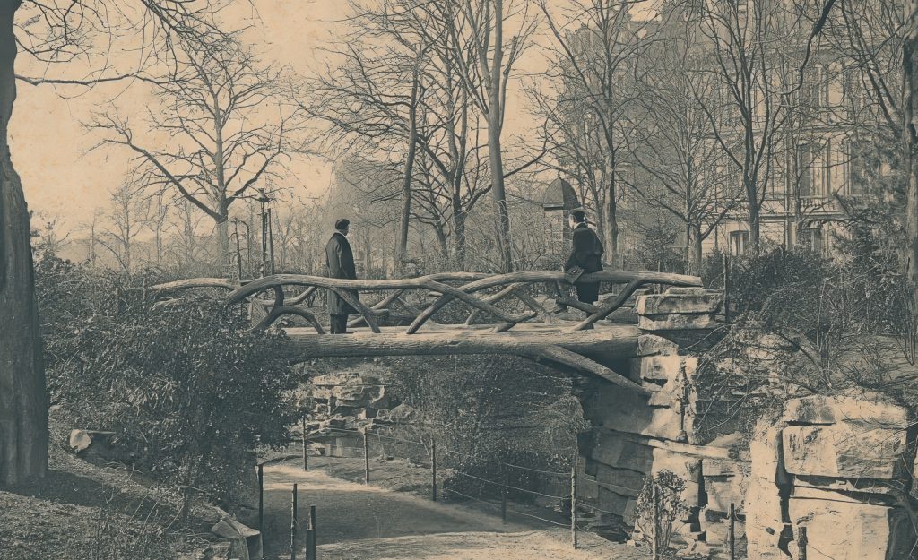 a faux bois bridge in Jardin de la Nouvelle France near the Grand Palais